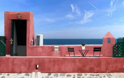 a table and chairs sitting on top of a building at Hartso - Traditional loft, renovated former forge in Gennadi in Gennadi