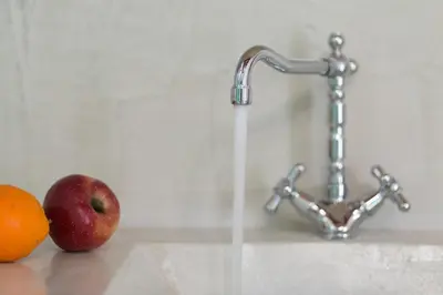 an apple and an orange next to a water faucet at Hartso - Traditional loft, renovated former forge in Gennadi in Gennadi