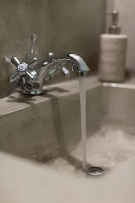a bathroom sink with a water faucet at Hartso - Traditional loft, renovated former forge in Gennadi in Gennadi