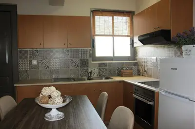 a kitchen with a table with a bowl of food on it at Miva Sea View in Faliraki
