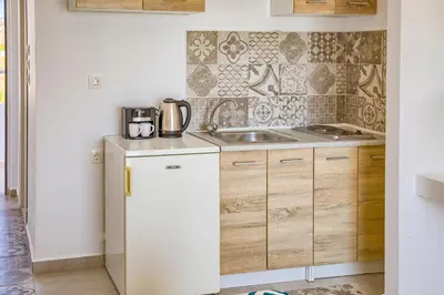 a kitchen with a sink and a counter top at Tommy's Rooms in Haraki