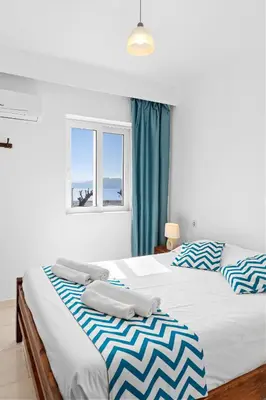 a bedroom with two beds with towels on them at Tommy's Rooms in Haraki