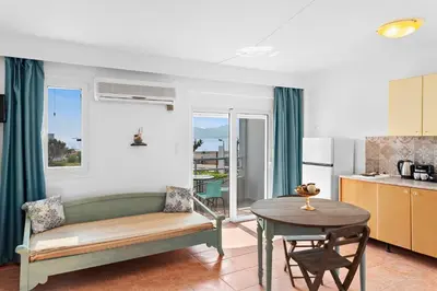 a living room with a couch and a table at Tommy's Rooms in Haraki
