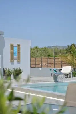 a view of a swimming pool from a house at Tommy's Rooms in Haraki