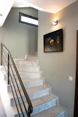 a staircase with a painting on the wall at Villa Oliva Rodos in Ialyssos