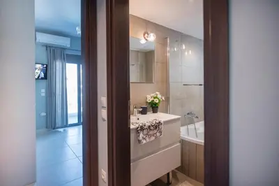 a bathroom with a sink and a bath tub at Villa Oliva Rodos in Ialyssos