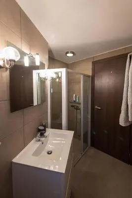 a bathroom with a white sink and a shower at Villa Oliva Rodos in Ialyssos