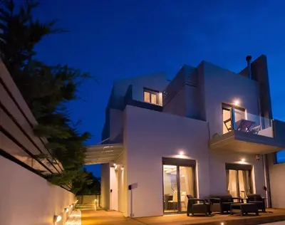 a white house at night with lights at Villa Oliva Rodos in Ialyssos