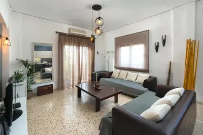 a living room with a couch and a table at Cozy City Apartment in Rhodes Town