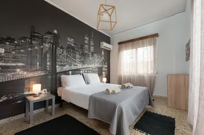 a bedroom with a bed and a black wall at Cozy City Apartment in Rhodes Town