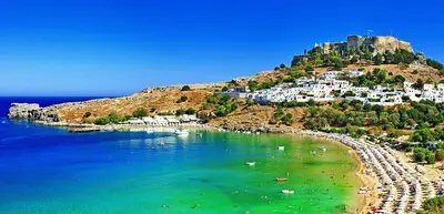 a view of a beach with a castle on a hill at Cozy City Apartment in Rhodes Town