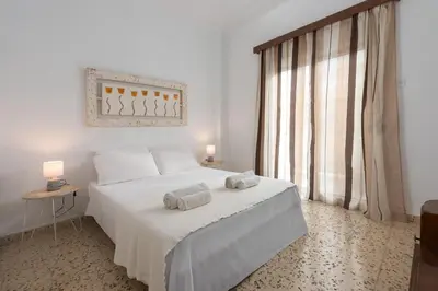 a bedroom with a white bed with towels on it at Cozy City Apartment in Rhodes Town
