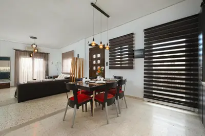 a dining room with a table and red chairs at Cozy City Apartment in Rhodes Town