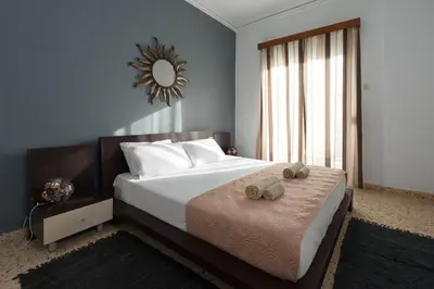 a bedroom with a large bed with two towels on it at Cozy City Apartment in Rhodes Town