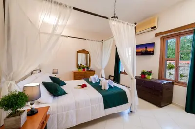 a bedroom with a bed and a dresser and a window at Emerald Dream House in Rhodes Town