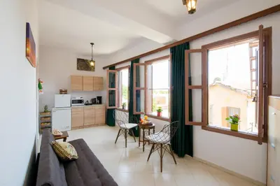a living room with a couch and a table at Emerald Dream House in Rhodes Town
