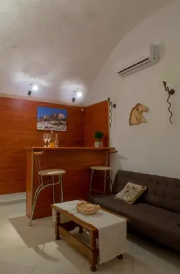 a living room with a couch and a table at Emerald Dream House in Rhodes Town