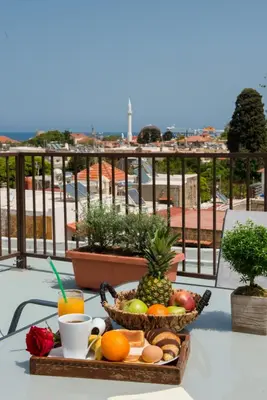 a tray of fruit on a table on a balcony at Emerald Dream House in Rhodes Town