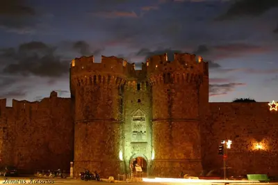 a castle at night with people standing in front of it at Emerald Dream House in Rhodes Town