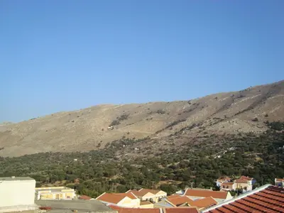 a view of a mountain with a town and houses at Horio Village Rooms in Symi