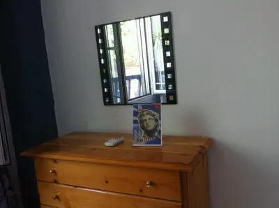 a mirror sitting on top of a wooden dresser at Apollon Apartments H-2 in Rhodes Town