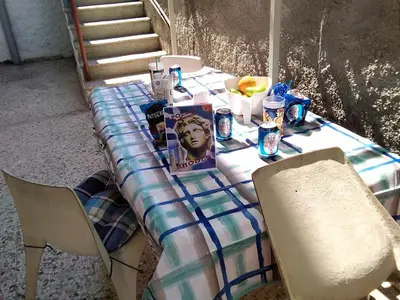 a table with a table cloth on it with chairs at Apollon Apartments H-2 in Rhodes Town