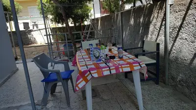 a table with a colorful table cloth and two chairs at Apollon Apartments H-2 in Rhodes Town