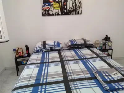 a bed in a room with a poster on the wall at Apollon Apartments H-1 in Rhodes Town