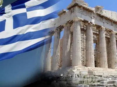 a greek flag flying in front of a building at Apollon Apartments H-1 in Rhodes Town