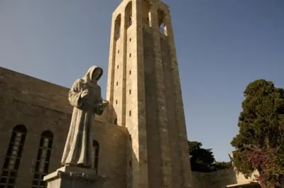 a statue in front of a building with a clock tower at Apollon Apartments H-1 in Rhodes Town
