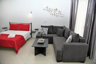 a living room with a couch and a bed at City Heart Luxury Studios in Rhodes Town