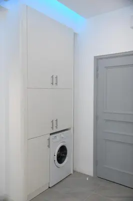 a white laundry room with a washer and dryer at City Heart Luxury Studios in Rhodes Town