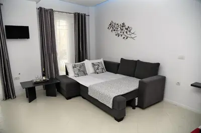 a living room with a couch and a table at City Heart Luxury Studios in Rhodes Town