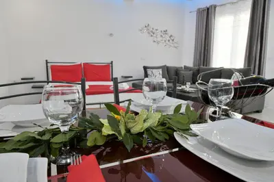 a dining room with a table with wine glasses on it at City Heart Luxury Studios in Rhodes Town