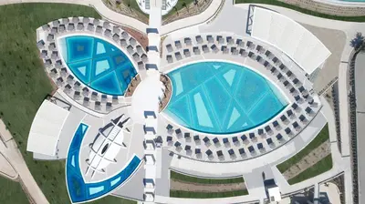 an overhead view of two swimming pools in a resort at Mayia Exclusive Resort & Spa - Adults Only in Kiotari