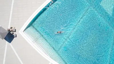 an overhead view of a person swimming in a swimming pool at Mayia Exclusive Resort & Spa - Adults Only in Kiotari