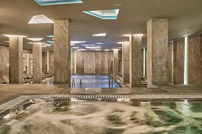 a large pool of water in a room with columns at Mayia Exclusive Resort & Spa - Adults Only in Kiotari