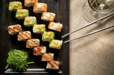 a plate of food with sushi on a table at Mayia Exclusive Resort & Spa - Adults Only in Kiotari
