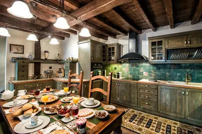 a kitchen with a table with food on it at Lemuria Manor, Wine Dark Sea Villas in Rhodes Town