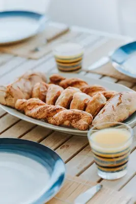 a plate of pastries on a wooden table at Anssami Villa in Rhodes Town