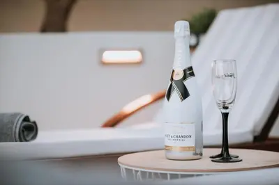 a bottle of champagne and a glass on a table at Anssami Villa in Rhodes Town