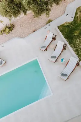 an overhead view of a swimming pool and two lounge chairs at Anssami Villa in Rhodes Town