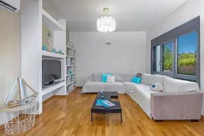 a living room with a couch and a tv at Anssami Villa in Rhodes Town