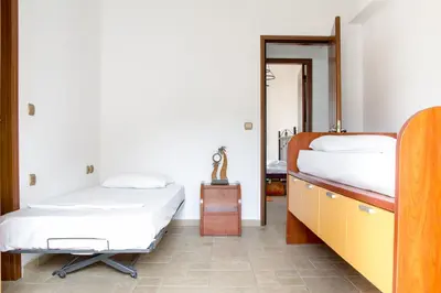 a bedroom with two beds and a mirror at Kaya Sea Apts - Stegna Beach in Archangelos
