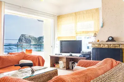 a living room with a fireplace and a television at Kaya Sea Apts - Stegna Beach in Archangelos