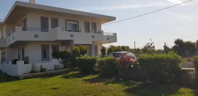 a house with a car parked in front of it at Sea Spirit in Afantou