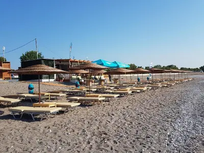 a row of chairs and umbrellas on a beach at Sea Spirit in Afantou