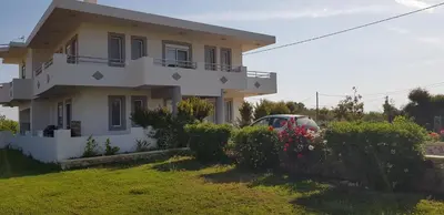 a house with a car parked in front of it at Sea Spirit in Afantou