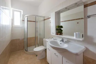 a bathroom with a sink and a shower and a toilet at Sea Spirit in Afantou