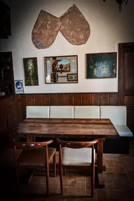 a wooden table with chairs and a bow tie on the wall at Nymph in Sálakos